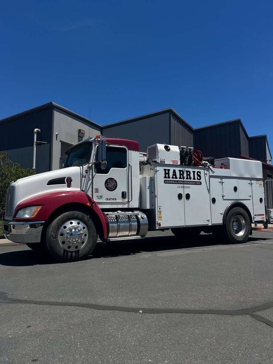 Red and white Kenworth service truck carrying Harris General Engineering graphics on the cab and service body