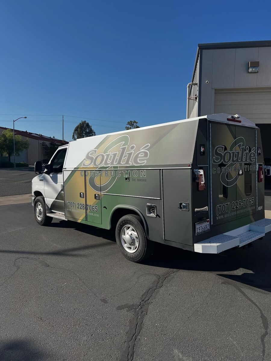 White Soulié Construction box van wearing the green and gold diagonal livery with the script wordmark on the body