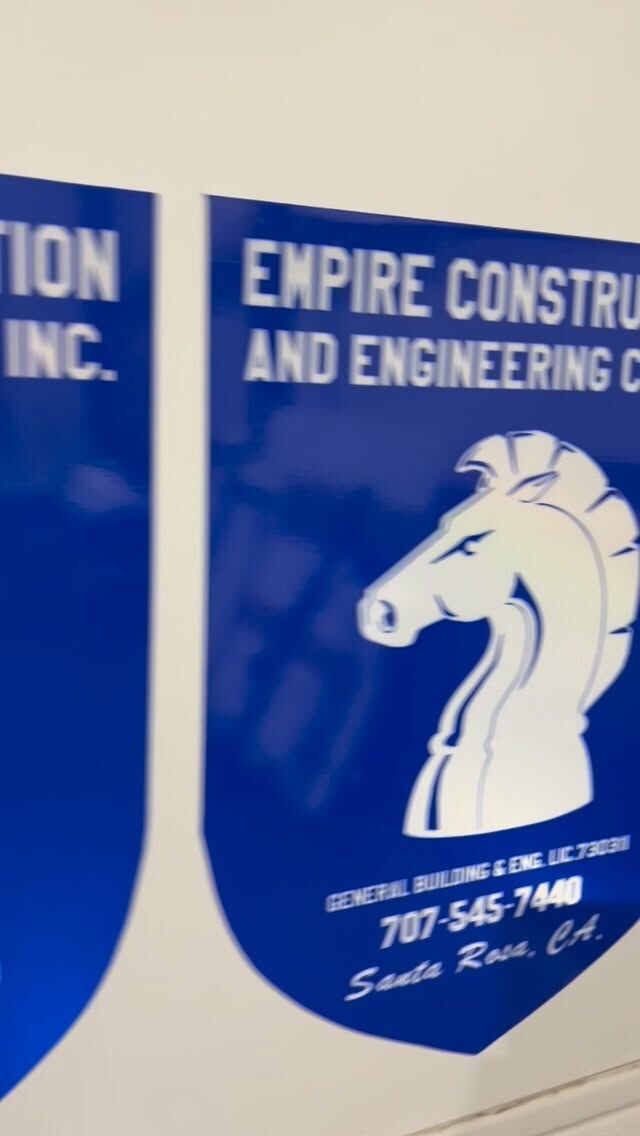 Blue vehicle panel carrying the Empire Construction and Engineering wordmark and a white knight chess-piece mark