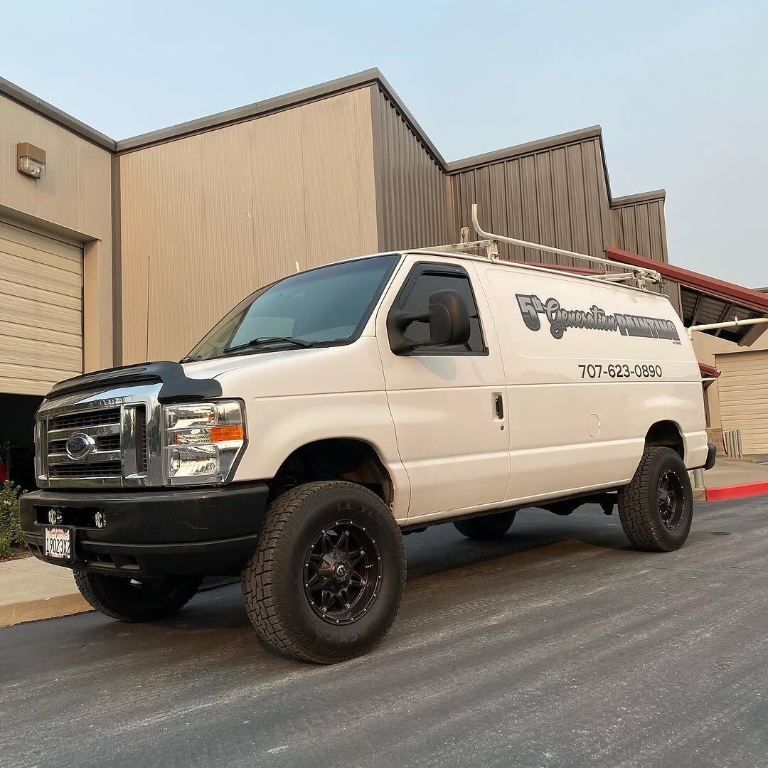 White Ford Econoline van with 5th Generation Painting lettering and a phone number along the side