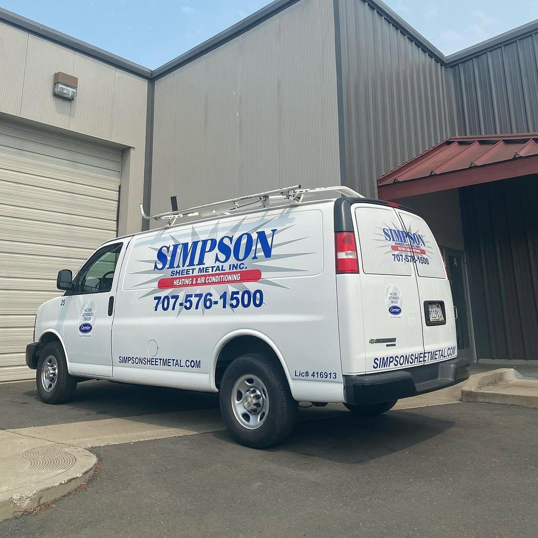 White Chevrolet Express van carrying blue Simpson Sheet Metal graphics and a large phone number