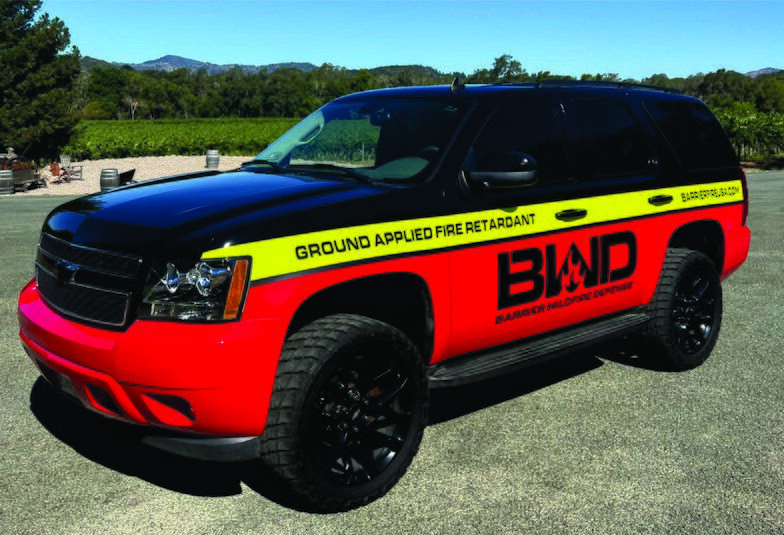 Chevrolet Tahoe in a full red, black and yellow wrap for Barrier Wildfire Defense, photographed in a Sonoma County vineyard